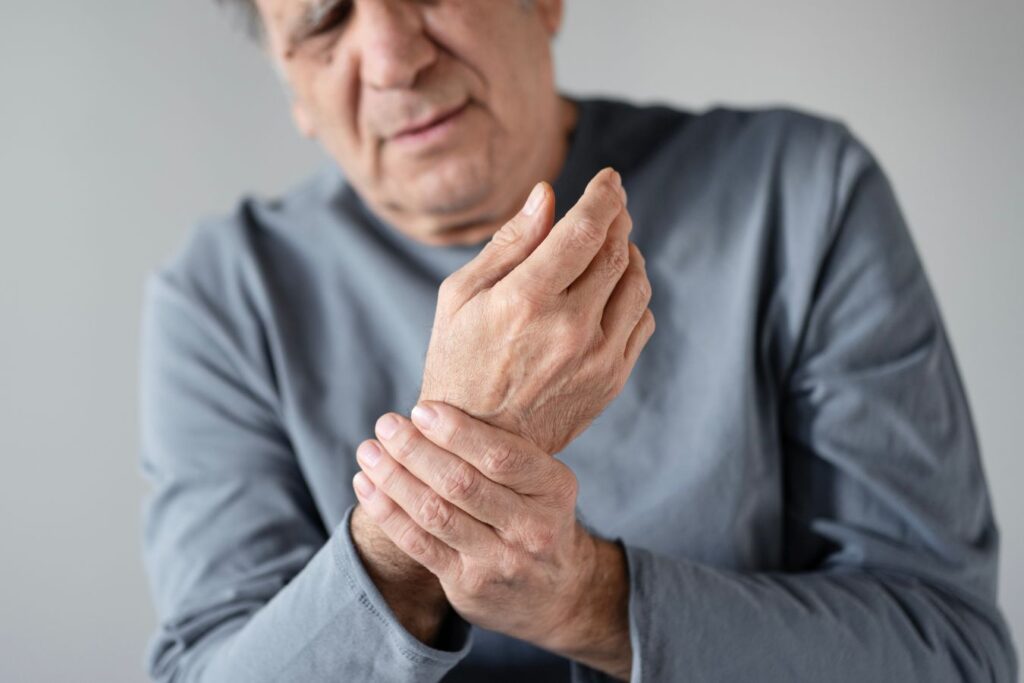 Čovjek se drži za zglob ruke jer osijeća bolove koji mogu biti jedan od znakova osteoporoze.