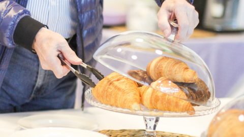 Croissant, coffee, people eating